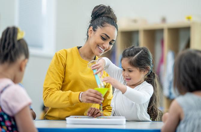 early childhood educator in classroom with children