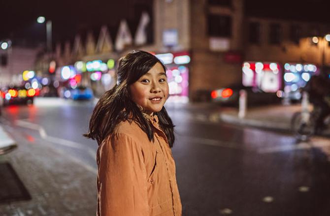 girl in winter walking on a busy street