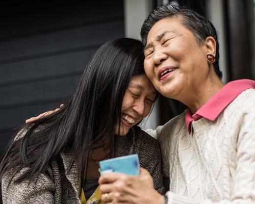 Grandmother and daughter hugging