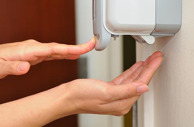 A person sanitizing their hands.