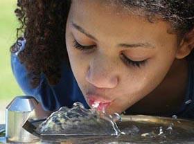 Girl drinking from water fountain