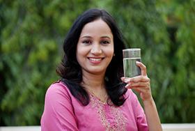 Person holding glass of water