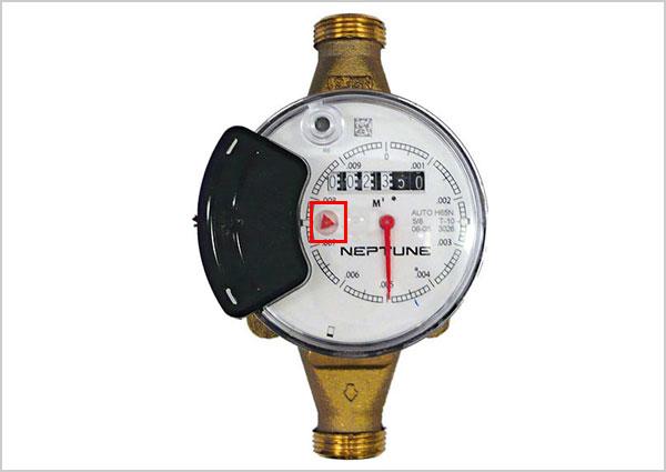 Water meter with 2 black wheels with low flow indicator highlighted