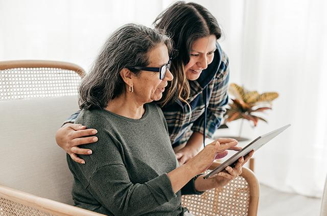 2 women looking at iPad