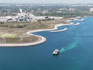 A barge collecting rock and soil samples from Lake Ontario near the G.E. Booth facility